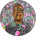 Man with glasses in a circular frame against a vibrant, abstract floral background.